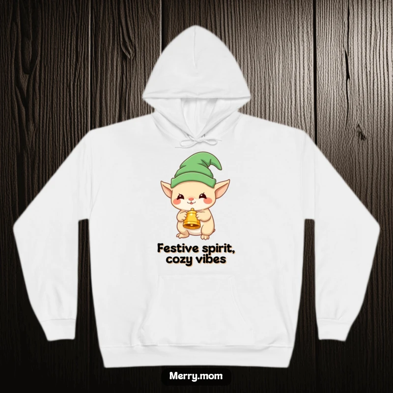Funny cozy hoodie with a cute elf creature wearing a hat and holding a festive bell, perfect for holiday warmth.